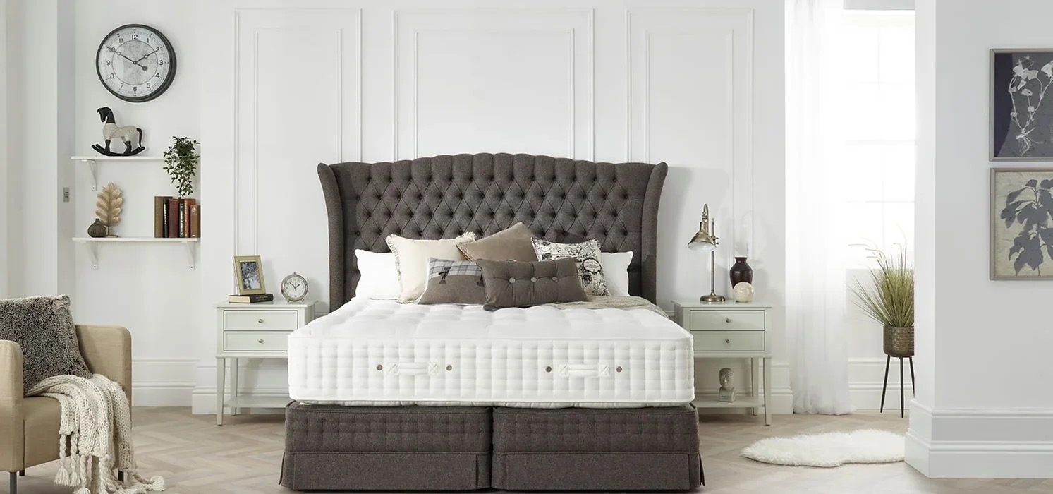 Deep-buttoned upholstered headboard in a styled bedroom