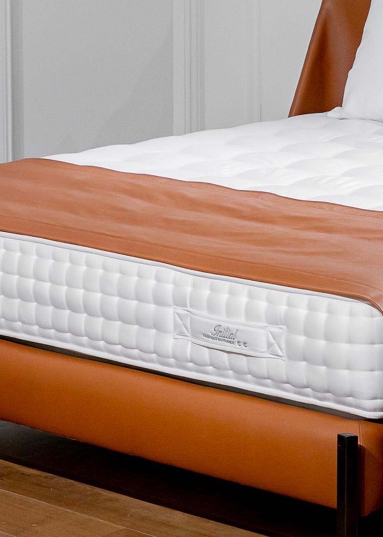 Tréca Platinum Initial bed dressed in a bedroom